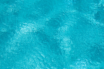 Pool water surface. Blue water texture. Close up blue water surface. Sea surface aerial view. Blue swimming poll water surface. Pattern texture.