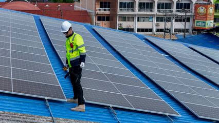 Worker Technicians are working to construct solar panels system on roof. Installing solar...