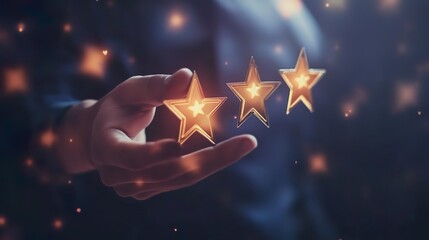 A hand holding three stars in a dark background