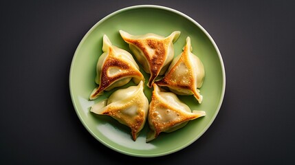 A plate of golden-brown dumplings arranged neatly, showcasing their crispy texture.