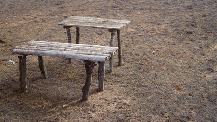 Tables and chairs made of wood and bamboo in the open space, look dirty