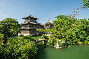 Chinese-style buildings and small bridges by the river.
