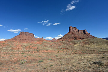 Red rock landscape along Utah State Route 128 near Moab on sunny summer afternoon.