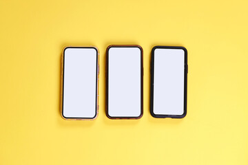 Smartphone Displaying White Blank Screen For Application Mockup Over Yellow Background