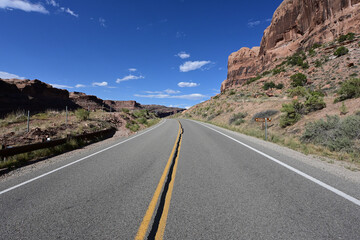 Red rock landscape along Utah State Route 128 near Moab on sunny summer afternoon.