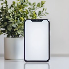 Modern Smartphone Mockup with Green Plant on White Background.
