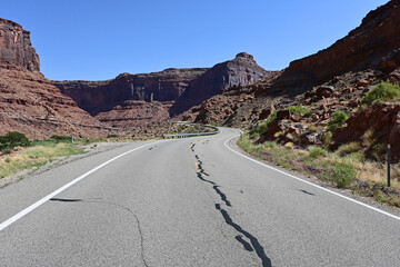 Red rock landscape along Utah State Route 128 near Moab on sunny summer afternoon.