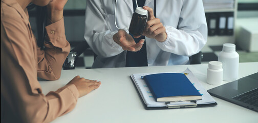 Doctor or physician recommend pills medical prescription to male Patient