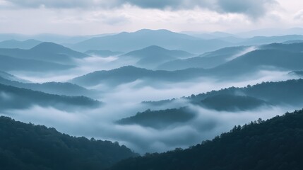 Misty Mountain Landscape with Layers of Fog and Blue Hues
