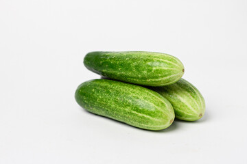 Whole and cut long cucumbers isolated on white