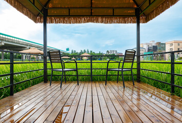 relaxing gazebo next to a rice paddy field after the rain