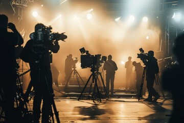Fototapeta premium Cinematic Film Crew Working on Stage with Cameras and Lights in a Foggy Light, Silhouetted Figures and Dramatic Lighting Captured in High-Resolution