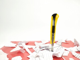 Picture of torn paper and a cutter 