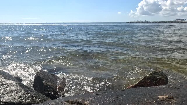 Waves swirl around jetty rocks at Fort Laduerdale intercoastal waterway