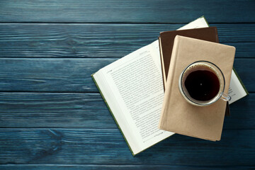 Books with a cup of coffee on a blue background