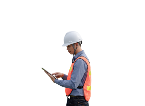 A man wearing a safety vest and a hard hat is looking at a tablet