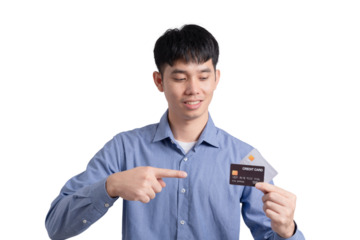 A man is holding a credit card and pointing to it