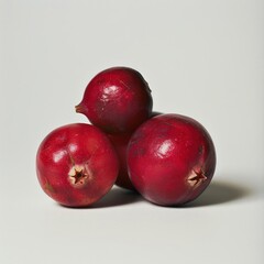 Obraz premium Three pomegranates, ripe and ready for consumption.