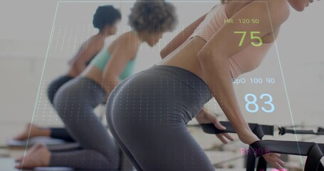 Heart rate and fitness data animation over women exercising in gym