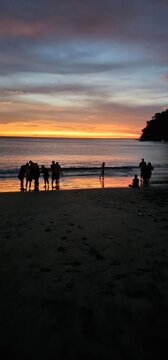 Silhouetted Figures on Playa El Jobo at Sunset, Guanacaste, Costa Rica; This scene encapsulates the serene beauty of the horizon, with silhouettes against the vibrant hues of the setting sun.