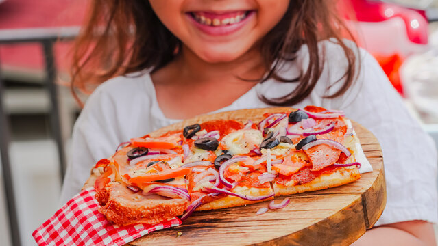 Slice of pepperoni pizza in hand isolated on white. Top view on paperoni pizza. Concept for italian food, street food, fast food, quick bite