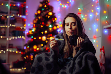 Sick Woman Feeling Feverish During Christmas Holidays. Person using natural remedies against common cold being unwell and alone 
