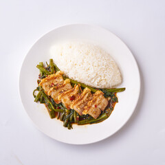 Delicious Thai Stir-Fried Tofu with Vegetables and Steamed Rice on a White Plate - Authentic Asian Cuisine