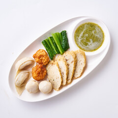 Boiled fish balls with dipping sauce and vegetables