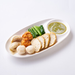 Boiled fish balls with dipping sauce and vegetables