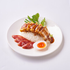 Red pork and crispy pork rice with Chinese sausage and egg on a white plate.