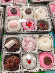 Colorful Donuts, Berliner, Krapfen with sugar icing and chocolate.
