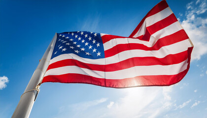 Obraz premium low angle of american flag waves in sky