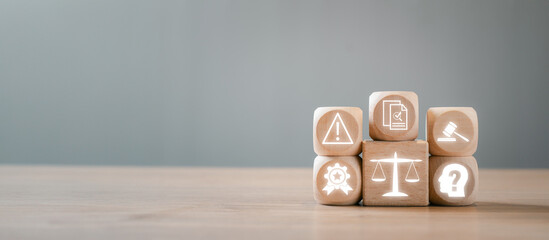 Wooden blocks with icons symbolizing regulation, compliance, and governance concepts on a wooden...