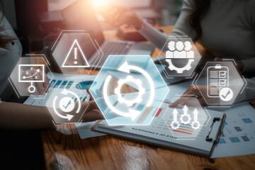 Team collaborating on business continuity planning with digital icons overlay, ensuring seamless operations and risk management.