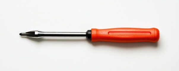 Fototapeta premium A red tool with a silver handle. The screwdriver is laying on a white surface
