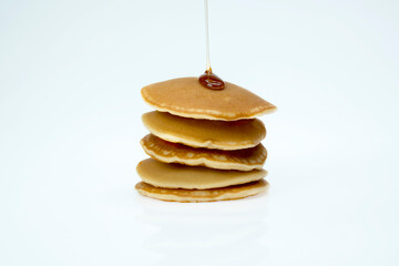 A stack of pancakes with syrup on top