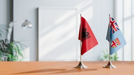 FLAGS OF ALBANIA AND FIJI ON TABLE