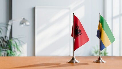 FLAGS OF ALBANIA AND GABON ON TABLE