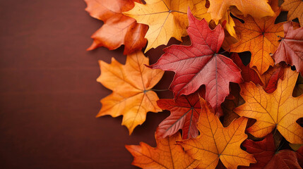 Fototapeta premium Vibrant autumn leaves in shades of red and orange, beautifully arranged against a warm background, capturing the essence of fall.