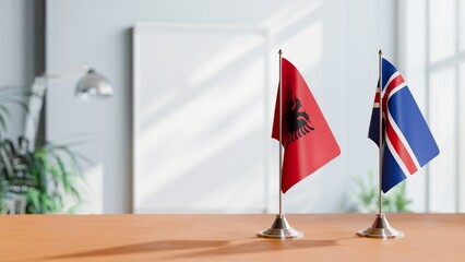 FLAGS OF ALBANIA AND ICELAND ON TABLE