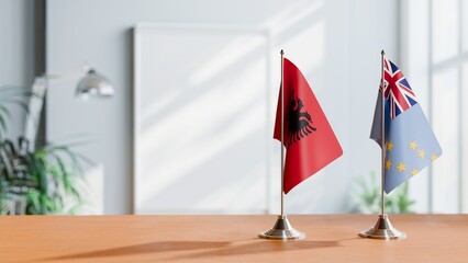FLAGS OF ALBANIA AND TUVALU ON TABLE