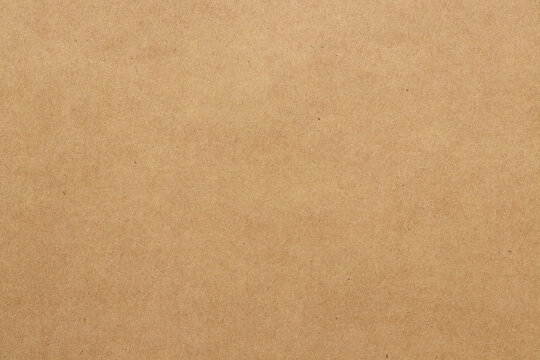 Brown cardboard sheet abstract background, texture of sepia color kraft paper with vintage pattern for design art work.