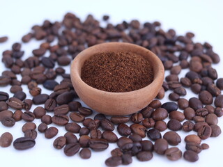 The coffee beans and the ground coffee isolated on white. 