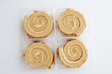 Coffee break roll cake in a clear box on white background