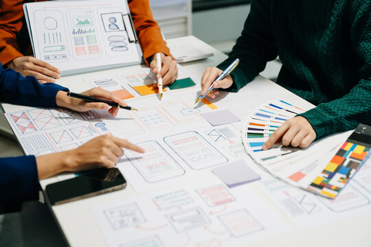 UX developer and ui designer brainstorming about mobile app interface wireframe design with customer breif - Powered by Adobe