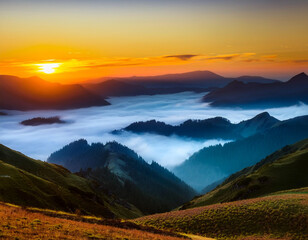 Fototapeta premium Landscape with sunset over the mountains with fog in the valley