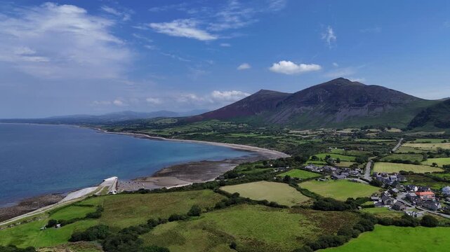 Trefor Beach, North Wales, Gyrn Goch and Gyrn Ddu mountains, harbor, clear waters and green fields