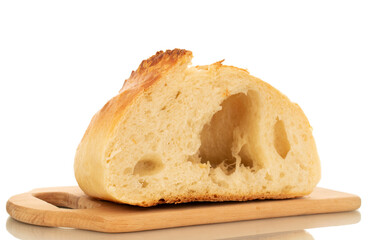 One half of white bread on a wooden kitchen board, macro, isolated on white background.