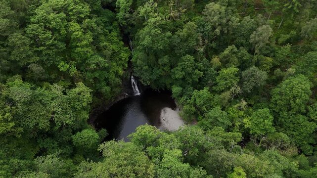 Man practicing Historical European martial arts by Rhaeadr Ddu waterfall, Ceunant Llennyrch gorge