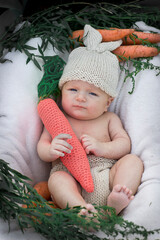 a child in a basket with carrots